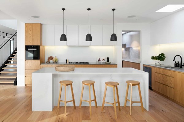 What's the Best Approach for a Kitchen Island that Serves as a Cooking, Dining, and Socializing Hub?